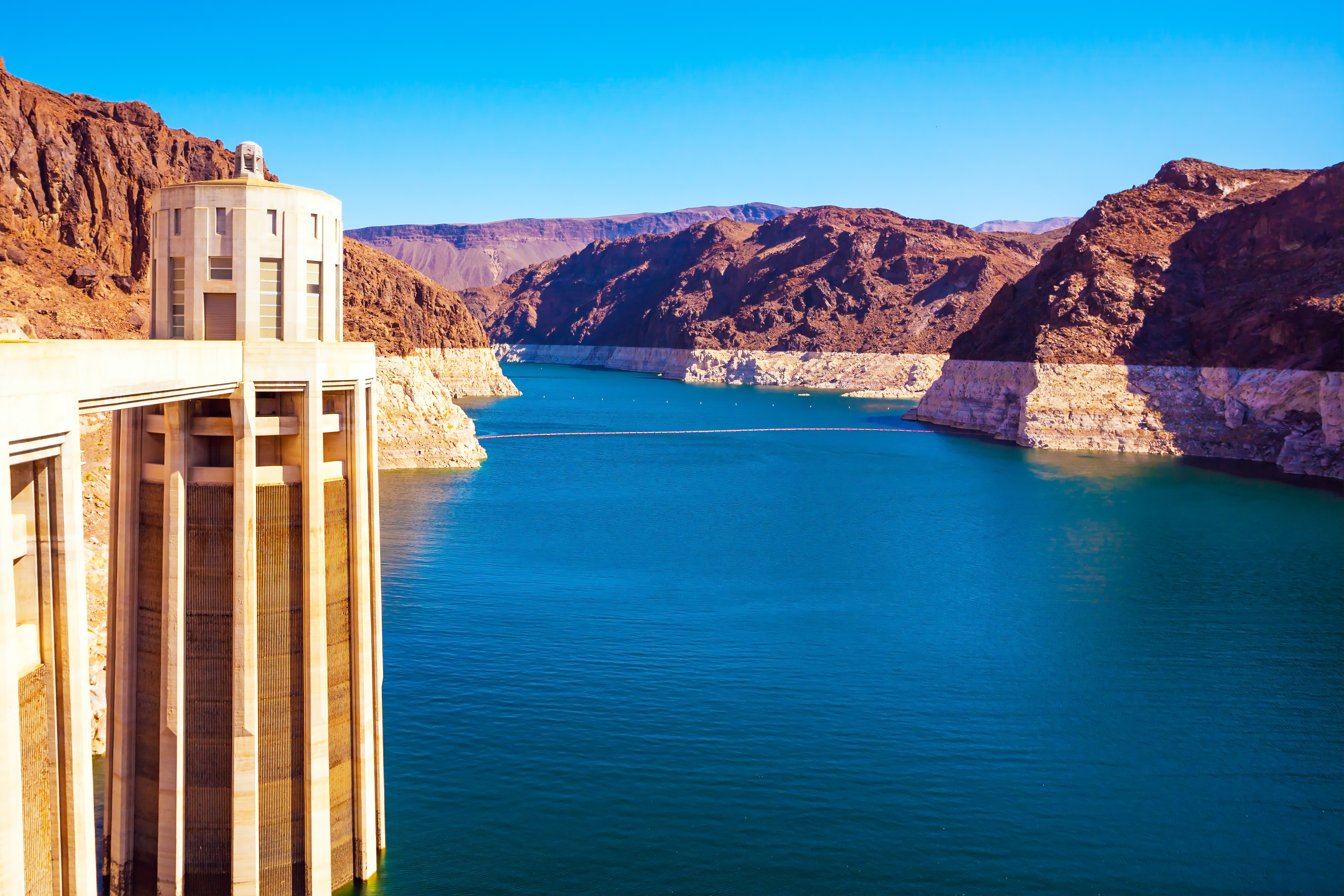 A thumbnail of a dam along the Colorado river with visible change in river level reflected in the surrounding rocks, which provides more information on the topic Colorado River Demands